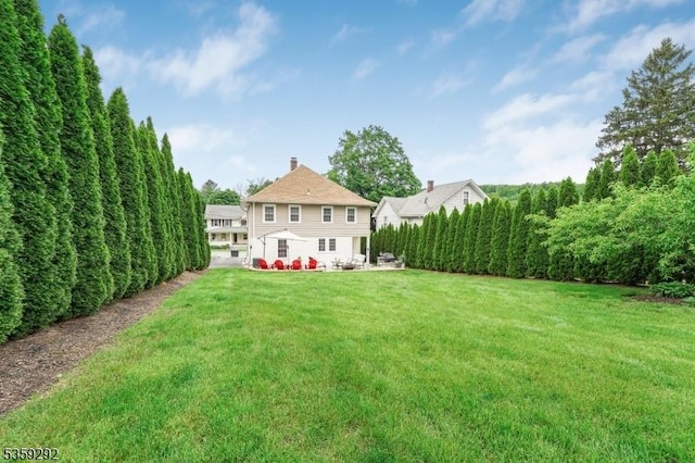 6 Highland Ave, Montville Twp, NJ 07045 - rear view of property with a yard, a chimney, and a patio area