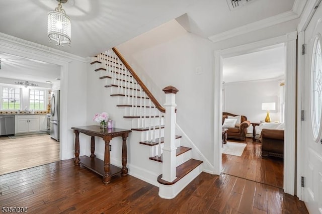 6 Highland Ave, Montville Twp, NJ 07045 - stairs featuring hardwood / wood-style flooring, ornamental molding, a chandelier, and baseboards