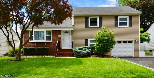 99 Mapes Ave, Springfield Twp, NJ 07081 - split level home featuring an attached garage, asphalt driveway, a front yard, and entry steps