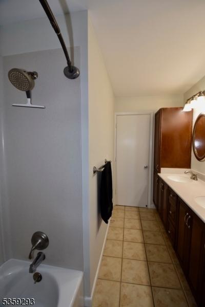 99 Mapes Ave, Springfield Twp, NJ 07081 - full bathroom with tile patterned floors, double vanity, and  shower combination
