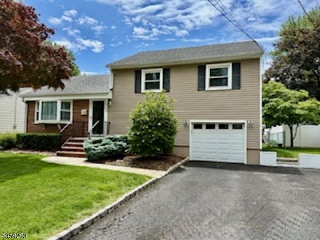 99 Mapes Ave, Springfield Twp, NJ 07081 - tri-level home with a garage, driveway, and a front lawn