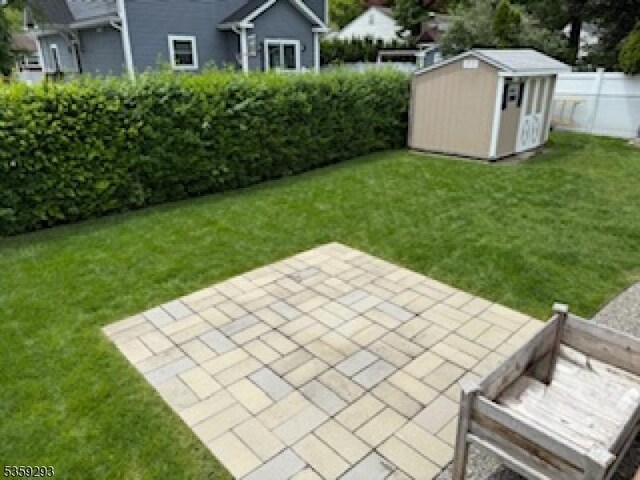99 Mapes Ave, Springfield Twp, NJ 07081 - view of yard featuring a patio and a storage shed