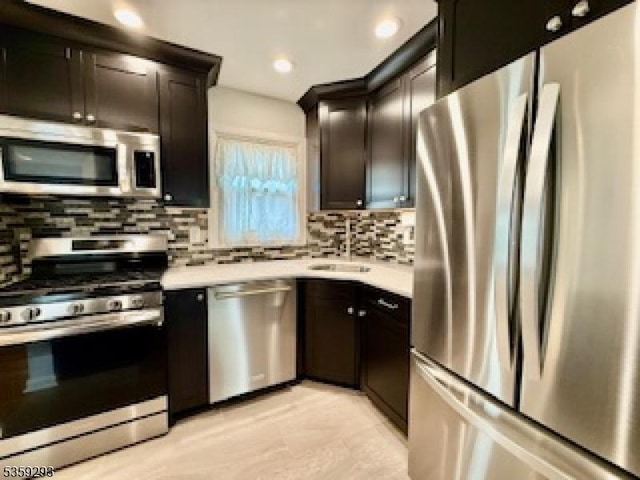 99 Mapes Ave, Springfield Twp, NJ 07081 - kitchen featuring stainless steel appliances, backsplash, light countertops, recessed lighting, and light tile patterned floors