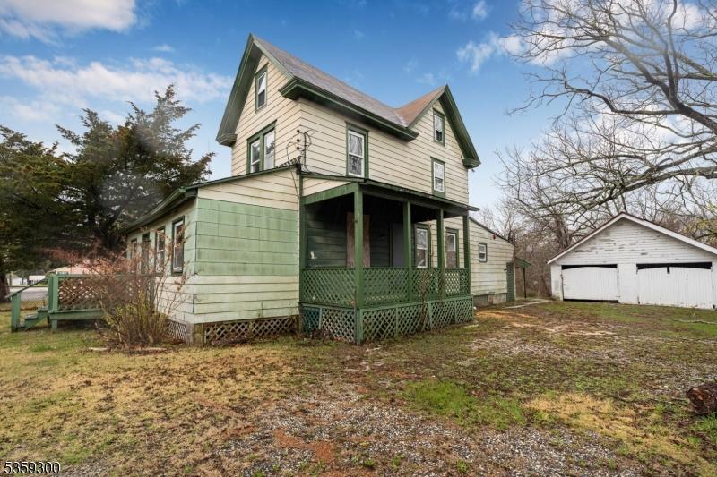 611-615 S New York Rd, Galloway Twp, NJ 08205 - view of side of property with covered porch, an outdoor structure, and a detached garage