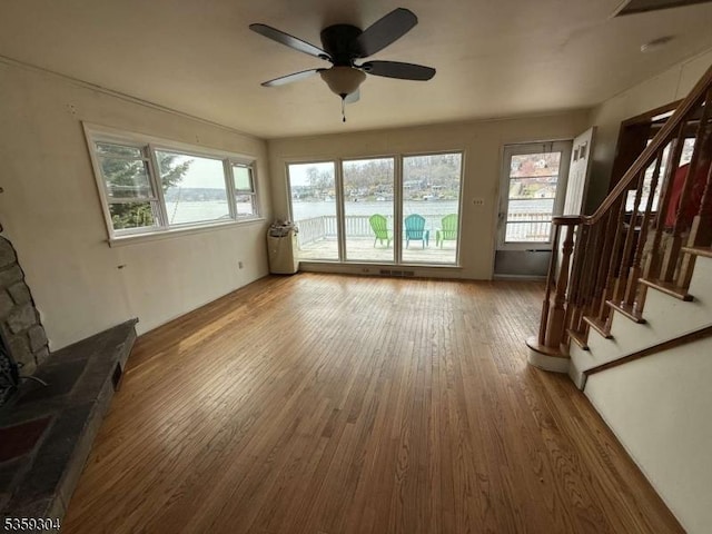 66 Ithanell Rd, Hopatcong Boro, NJ 07843 - unfurnished living room featuring a ceiling fan, healthy amount of natural light, stairway, and wood finished floors