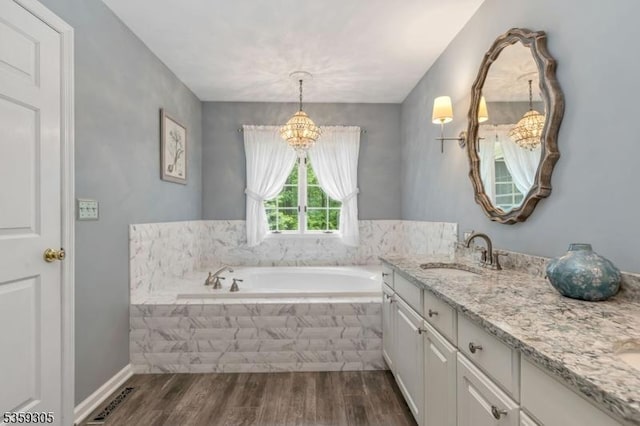 785 Backhus Estate Rd, Lebanon Twp, NJ 08826 - bathroom with a chandelier, vanity, wood finished floors, and a garden tub