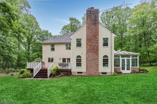 785 Backhus Estate Rd, Lebanon Twp, NJ 08826 - rear view of property featuring a chimney, a sunroom, a wooden deck, a yard, and french doors