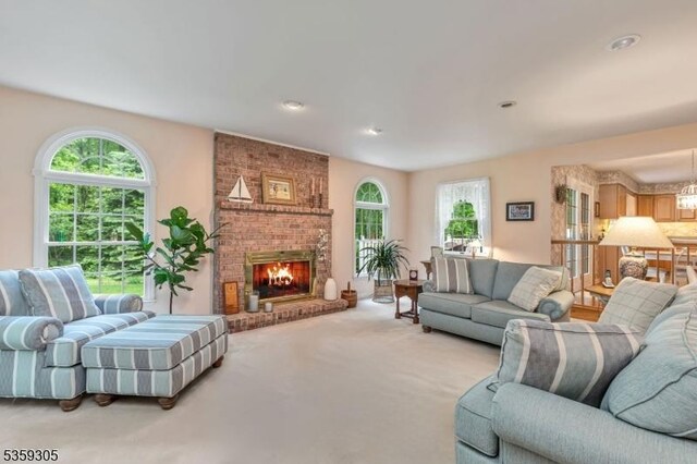 785 Backhus Estate Rd, Lebanon Twp, NJ 08826 - carpeted living area with plenty of natural light, a brick fireplace, a chandelier, and recessed lighting