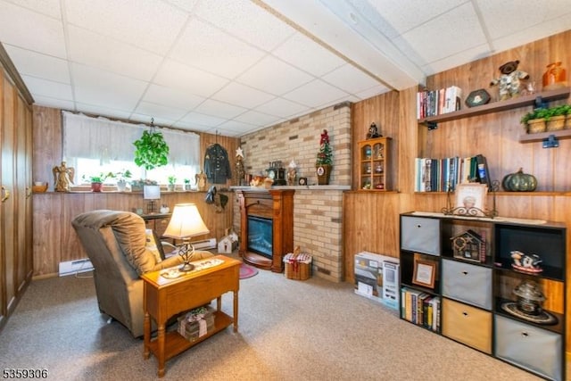 6 Gardenia Rd, Vernon Twp, NJ 07418 - carpeted living area featuring a drop ceiling, wood walls, a fireplace, and baseboard heating