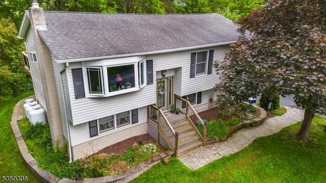 6 Gardenia Rd, Vernon Twp, NJ 07418 - raised ranch with a chimney, roof with shingles, and a front yard