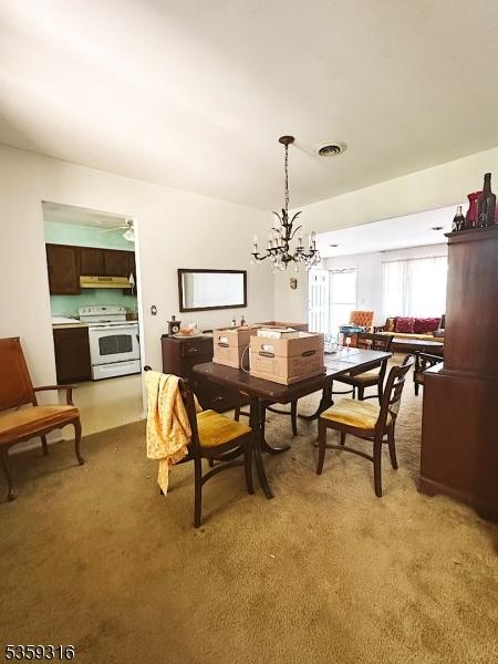 6 Langley Rd, Berkeley Twp, NJ 08757 - dining area featuring a chandelier and light colored carpet