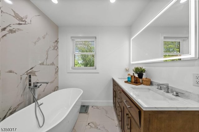 190 Riverside Dr, Springfield Twp, NJ 07081 - bathroom featuring vanity, marble look tiles, a freestanding tub, recessed lighting, and baseboards