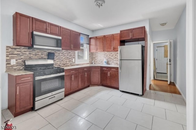 171 Sherman Ave, Newark City, NJ 07114 - kitchen with stainless steel appliances and decorative backsplash