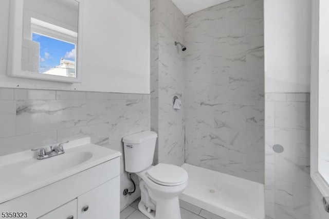 171 Sherman Ave, Newark City, NJ 07114 - bathroom with a marble finish shower, vanity, toilet, tile walls, and wainscoting