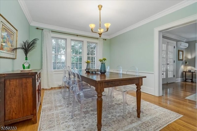 48 Baltusrol Way, Millburn Twp, NJ 07078 - dining space with light wood finished floors, a chandelier, ornamental molding, a wall mounted air conditioner, and french doors
