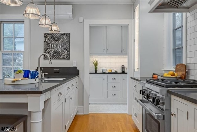 48 Baltusrol Way, Millburn Twp, NJ 07078 - kitchen featuring dark countertops, a sink, high end stove, backsplash, and ornamental molding