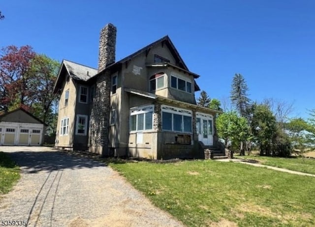 25 Prospect Ave, Andover Boro, NJ 07821 - view of front of house with an outbuilding, a chimney, a front yard, a detached garage, and entry steps