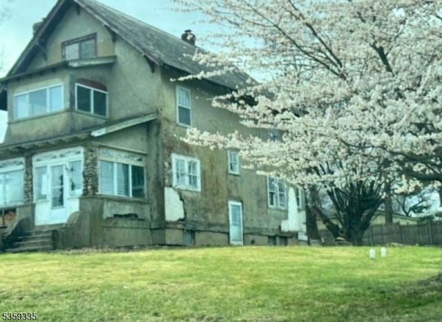 25 Prospect Ave, Andover Boro, NJ 07821 - view of side of home with stucco siding and a chimney