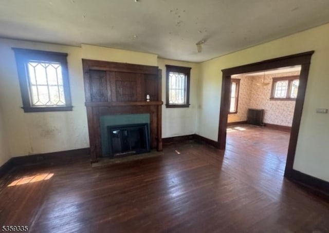 25 Prospect Ave, Andover Boro, NJ 07821 - unfurnished living room featuring wood finished floors, a glass covered fireplace, healthy amount of natural light, and baseboards