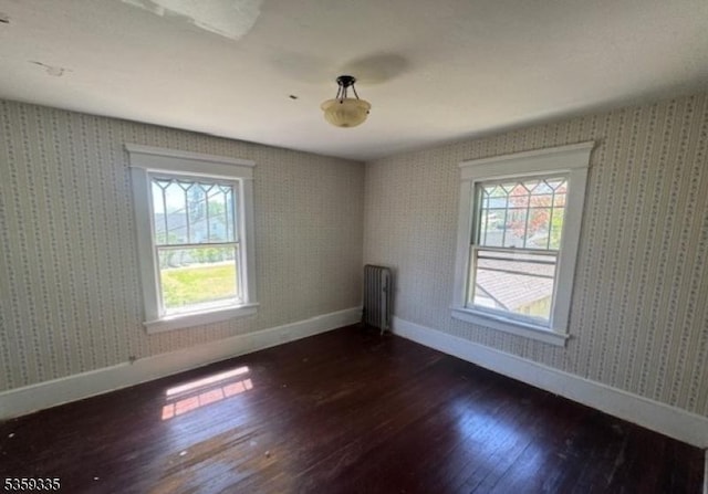 25 Prospect Ave, Andover Boro, NJ 07821 - empty room featuring baseboards, dark wood-type flooring, radiator heating unit, and wallpapered walls