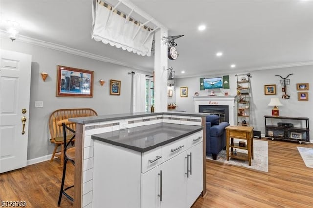 85 Smithfield Ct, Bernards Twp, NJ 07920 - kitchen with crown molding, open floor plan, light wood-type flooring, recessed lighting, and white cabinetry