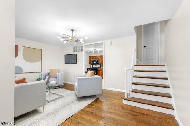 1190 Union St, Linden City, NJ 07036 - living room with wood finished floors, stairway, a chandelier, and baseboards