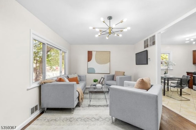 1190 Union St, Linden City, NJ 07036 - living room with a chandelier, wood finished floors, and baseboards