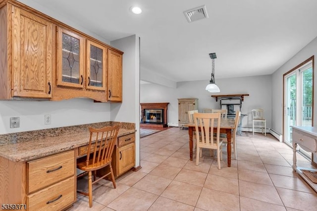 1 Lepont St, Stanhope Boro, NJ 07874 - dining space with light tile patterned flooring, built in study area, a glass covered fireplace, recessed lighting, and baseboard heating