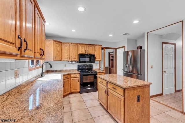 1 Lepont St, Stanhope Boro, NJ 07874 - kitchen featuring black appliances, light tile patterned floors, light stone countertops, a kitchen island, and recessed lighting