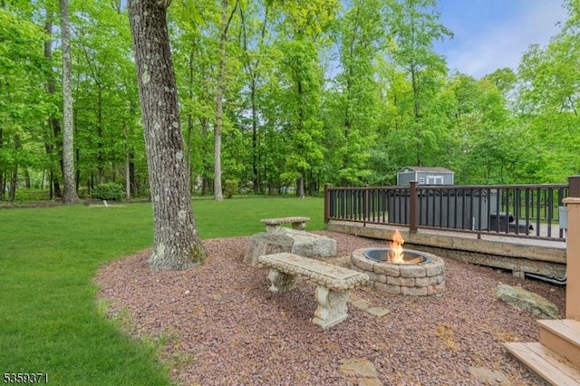 1 Lepont St, Stanhope Boro, NJ 07874 - view of green lawn featuring a shed, a fire pit, and a wooden deck