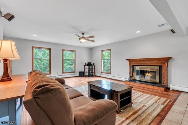 1 Lepont St, Stanhope Boro, NJ 07874 - living room with baseboard heating, ceiling fan, recessed lighting, a glass covered fireplace, and light wood-style floors