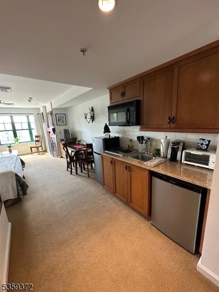 200 State Rt 94 Unit 259, Vernon Twp, NJ 07462 - kitchen featuring black microwave, light colored carpet, a sink, and stainless steel dishwasher