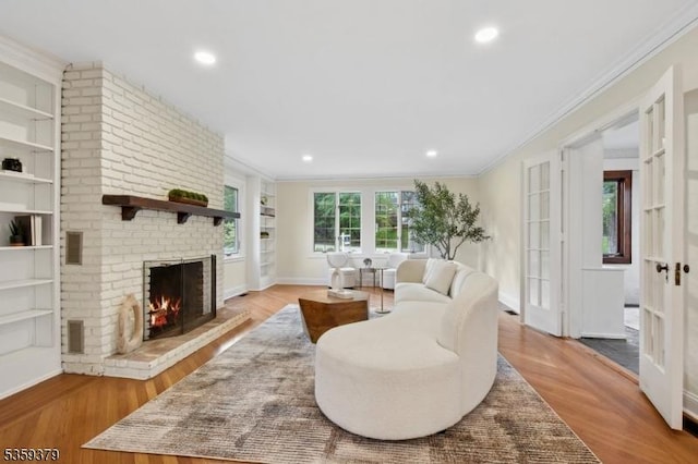 371 Franklin Pl S, Orange Village Twp, NJ 07079 - living area with ornamental molding, a brick fireplace, built in shelves, wood finished floors, and recessed lighting