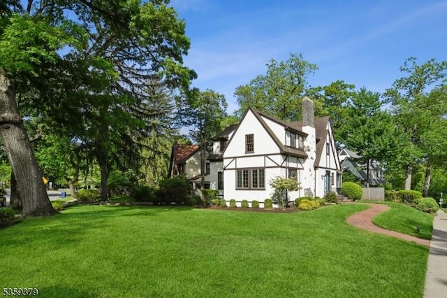 371 Franklin Pl S, Orange Village Twp, NJ 07079 - view of side of home featuring a lawn, stucco siding, and a chimney