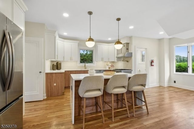 371 Franklin Pl S, Orange Village Twp, NJ 07079 - kitchen featuring freestanding refrigerator, wall chimney range hood, healthy amount of natural light, decorative backsplash, and recessed lighting