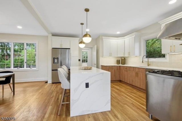 371 Franklin Pl S, Orange Village Twp, NJ 07079 - kitchen with stainless steel fridge with ice dispenser, stove, a center island, backsplash, and light wood-type flooring