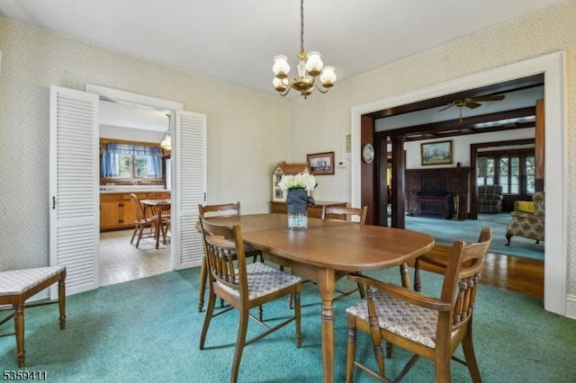 129 Severin Ct, Cranford Twp, NJ 07016 - carpeted dining room with ceiling fan, a chandelier, and a brick fireplace