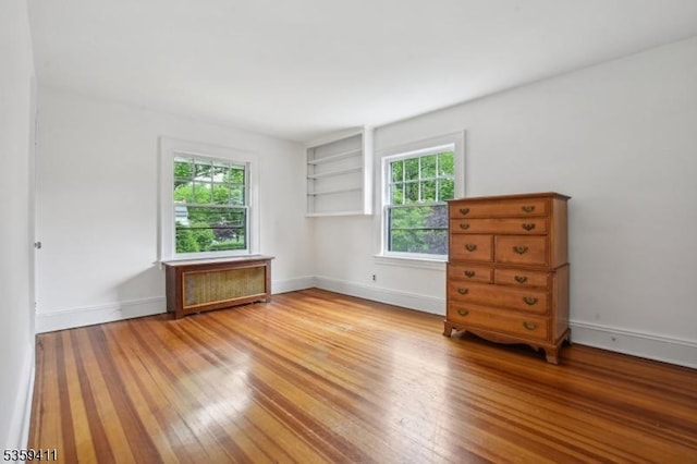 129 Severin Ct, Cranford Twp, NJ 07016 - empty room with light wood finished floors, baseboards, and built in features