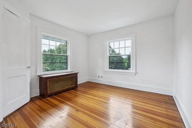 129 Severin Ct, Cranford Twp, NJ 07016 - unfurnished room featuring hardwood / wood-style floors, baseboards, and radiator