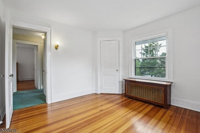 129 Severin Ct, Cranford Twp, NJ 07016 - unfurnished room with radiator, light wood-style floors, and baseboards