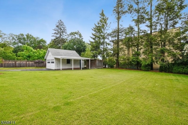 129 Severin Ct, Cranford Twp, NJ 07016 - view of yard featuring a garage, asphalt driveway, and view of scattered trees