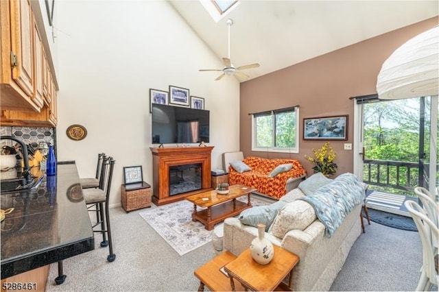 2 Sunrise Dr Unit 6, Vernon Twp, NJ 07462 - living area with a glass covered fireplace, carpet, a skylight, high vaulted ceiling, and a ceiling fan