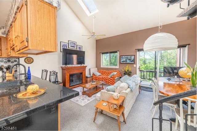 2 Sunrise Dr Unit 6, Vernon Twp, NJ 07462 - living room with a skylight, high vaulted ceiling, carpet flooring, a glass covered fireplace, and a ceiling fan