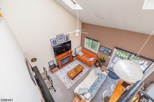 2 Sunrise Dr Unit 6, Vernon Twp, NJ 07462 - living area with high vaulted ceiling, a skylight, carpet, and a ceiling fan