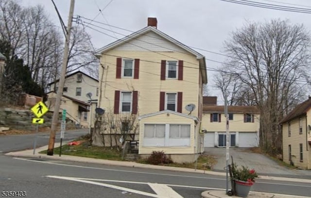 2-8 Harrison St, Sussex Boro, NJ 07461 - view of front facade with a chimney and a garage