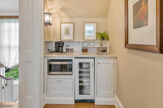 259 Indian Trail Dr, Franklin Lakes Boro, NJ 07417 - indoor wet bar featuring beverage cooler, stainless steel microwave, and plenty of natural light