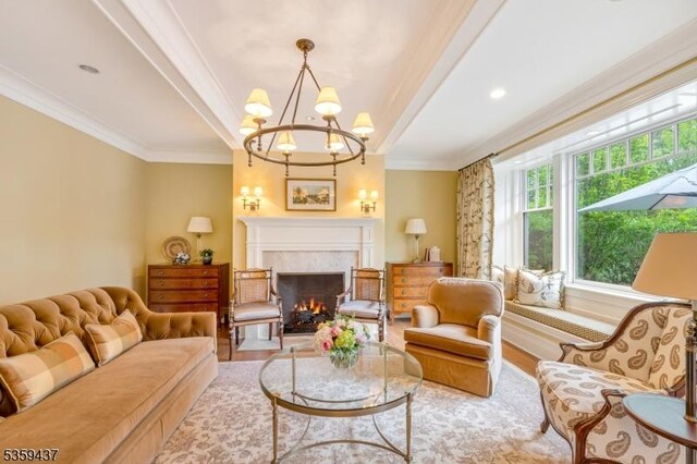 259 Indian Trail Dr, Franklin Lakes Boro, NJ 07417 - living room with a high end fireplace, ornamental molding, wood finished floors, and a chandelier