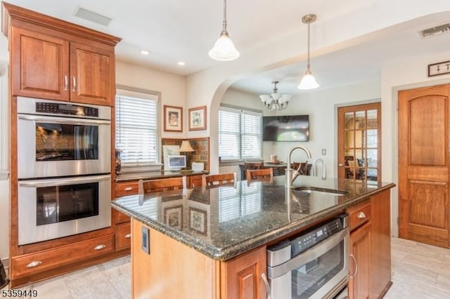 947 Madison Ave, Plainfield City, NJ 07060 - kitchen with stainless steel double oven, a sink, a chandelier, brown cabinets, and recessed lighting