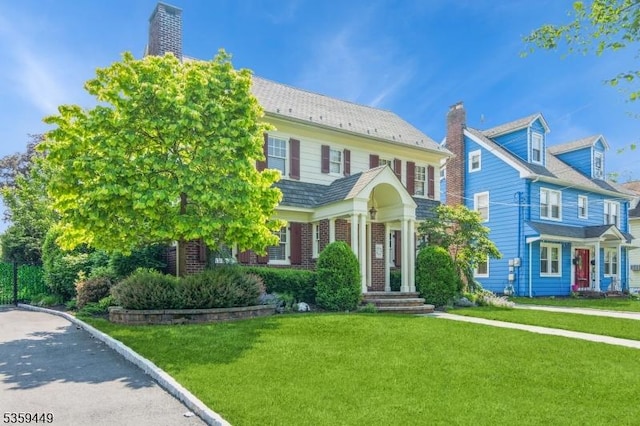 947 Madison Ave, Plainfield City, NJ 07060 - view of front facade featuring a front lawn, a chimney, and brick siding