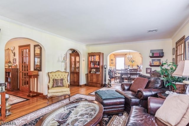 947 Madison Ave, Plainfield City, NJ 07060 - living room with arched walkways, wood finished floors, ornamental molding, and a chandelier